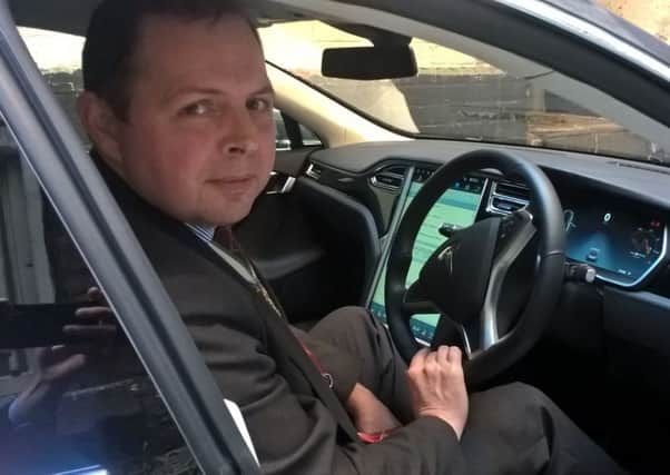 Master Cutler Craig McKay at the wheel of his Tesla
