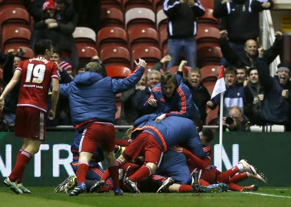 Middlesbrough's Adam Forshaw (hidden) celebrates with team-mates after scoring a late winner against Reading.