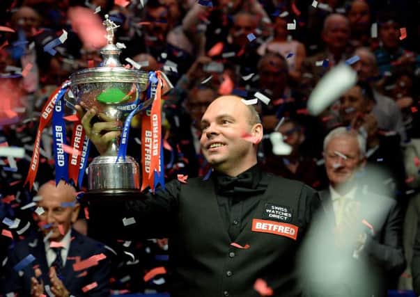 Stuart Bingham celebrates with the trophy after winning the Betfred World Championships at the Crucible Theatre, Sheffield. Picture: Anna Gowthorpe/PA.