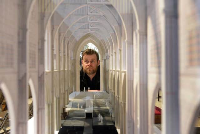 Designer  Max Jones looking at a model of how York Minster will be transformed for the plays