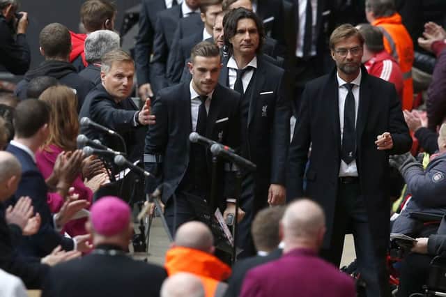 Manager Jurgen Klopp (right) and Jordan Henderson lead the players and staff as they arrive for the last memorial service to be held at Anfield