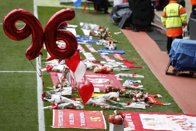 Flowers and balloons at the side of the pitch during the last memorial service to be held at Anfield