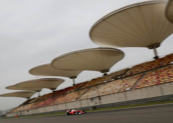 Ferrari driver Sebastian Vettel of Germany steers his car past the spectator's stand during the second practice session for the Chinese Formula One Grand Prix. Picture: AP/Andy Wong.