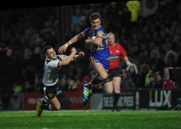 Leeds Rhinos' Ash Handley hands off Curtis Naughton. Picture: Steve Riding.