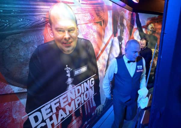 Defending World Champion Stuart Bingham walks out before his first round match at the Crucble Theatre in Sheffield. He lost 10-9 to Ali Carter. Picture: Anna Gowthorpe/PA.