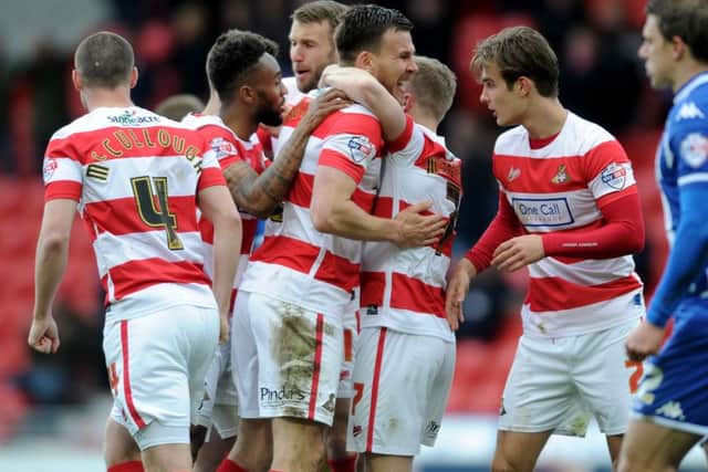 ABOUT TIME: Andy Butler (centre) celebrating with his Doncaster Rovers' team-mates as the hosts celebrated an overdue League One victory. Picture: James Hardisty.