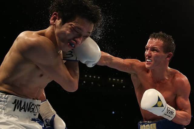 Josh Warrington (right) and Hisashi Amagasa during the WBC International Featherweight Championship bout at the First Direct Arena, Leeds.