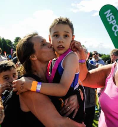 Bailey gets a kiss from his mother after finishing the Castle Howard Triathlon.