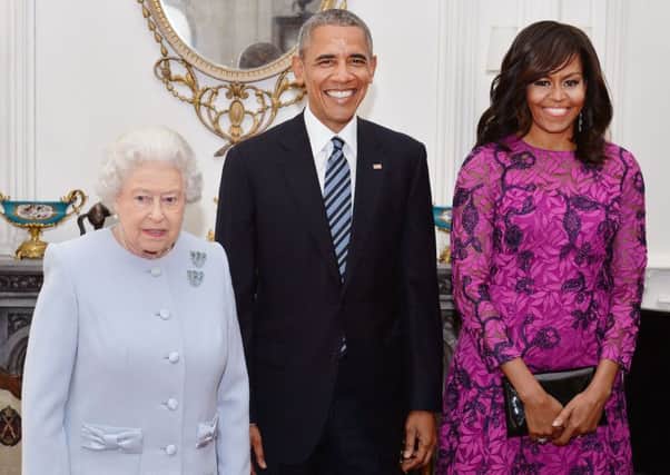 The Queen stands with President and First Lady Barack and Michelle Obama in the Oak Room at Windsor Castle