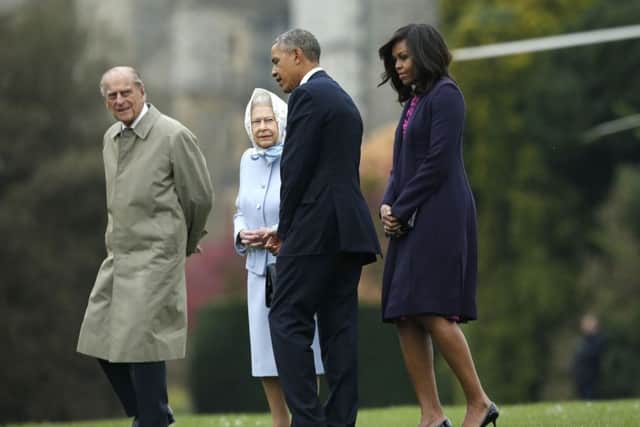 The President and First Lady of the United States Barack Obama and his wife Michelle (both right) are greeted by Queen Elizabeth II and the Duke of Edinburgh, after landing by helicopter in the grounds of Windsor Castle ahead of a private lunch hosted by the Queen. PRESS ASSOCIATION Photo. Picture date: Friday April 22, 2016. See PA story ROYAL Obama. Photo credit should read: Alastair Grant/PA Wire