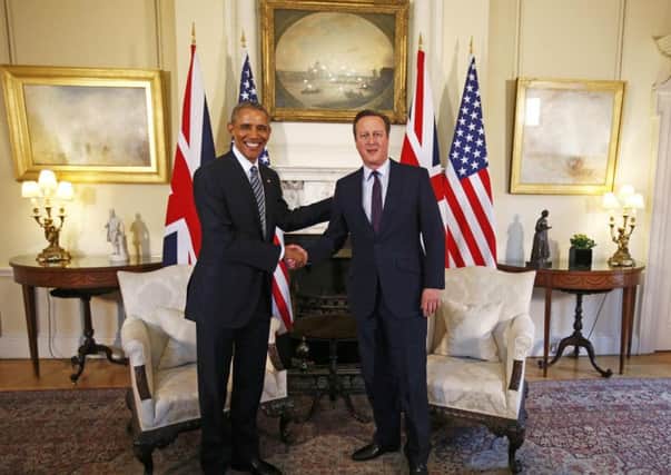 Prime Minster David Cameron (right)  greets US President Barack Obama, ahead of a bilateral meeting in 10 Downing Street, London.