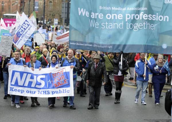 Campaigners marching in protest over proposed NHS reform.