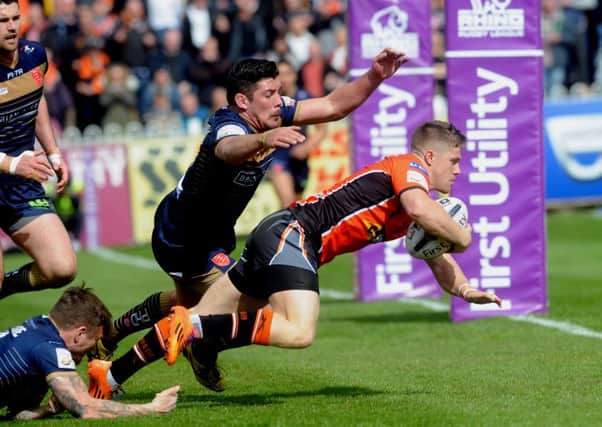 Castleford player Ryan Hampshire breaks through Hull KR defence to score a try.