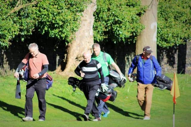Competitors make their way up a fairway during Castlefields GC's Lewis Broadley Shield, a drawn pairs competition.