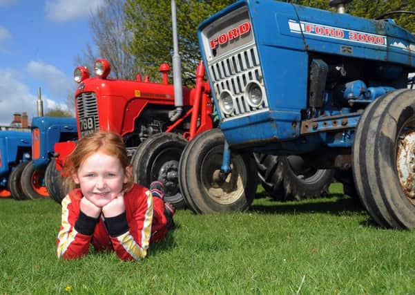 Charlotte Wilson takes time out from helping her father Colin put vintage tractors through their  paces ahead of Tractor Fest at Newby Hall in June.