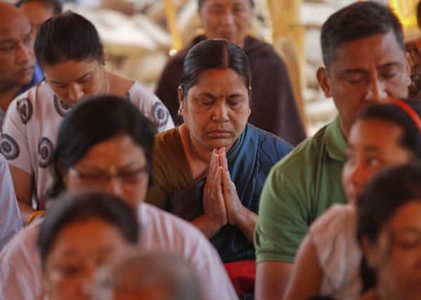 Nepalese people attend a prayer meeting in memory of people who died in last year's earthquake . (AP Photo/Niranjan Shrestha)