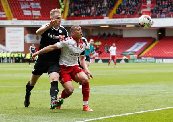 snuffed out: Barnsley central defender Marc Roberts, left, keeps Blades striker Che Adams in check at Bramall Lane. (Picture: Sport Images)