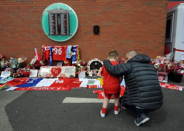 Fans arrive at the Hillsborough Memorial, at Anfield following yesterday's ruling. Picture by Simon Hulme