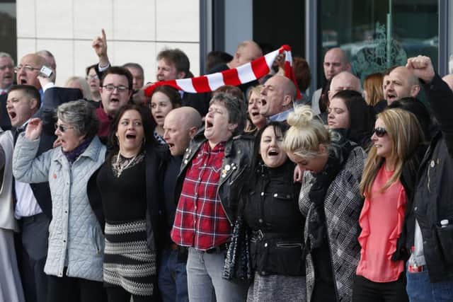 Relatives of those who died in the Hillsborough disaster sing You'll Never Walk Alone outside the Hillsborough inquests in Warrington, where the inquest jury concluded that the 96 Liverpool fans who died were unlawfully killed. PRESS ASSOCIATION Photo. Picture date: Tuesday April 26, 2016. See PA story INQUEST Hillsborough. Photo credit should read: Joe Giddens/PA Wire