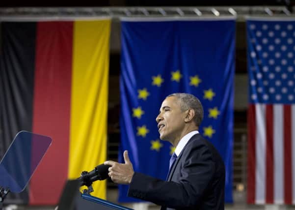 U.S President Barack Obama speaks in front of the flags of Germany, the European Union and the U.S at the Hannover Messe Trade Fair in Hannover, Germany.