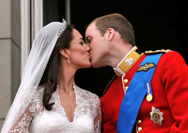 Prince William and his wife Kate, kiss on the balcony of Buckingham Palace, following their wedding at Westminster Abbey. Photo: John Stillwell/PA Wire