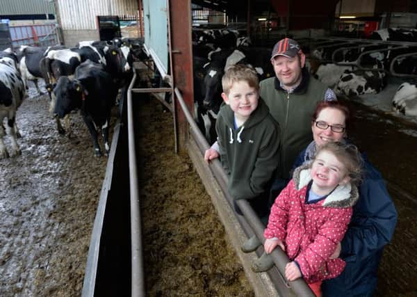 Craig and Rachael Bentley with Matthew, eight, and Isla, two, in the cattle shed at The Gables, Kepwick near Thirsk.  Pic: Bruce Rollinson