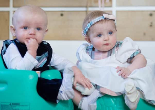 The Diana Award Collection by Seraphine, modelled by six-month-old twins Jude in playsuit, Â£69, and Martha Jean in white dress, Â£65. All body suits, socks and tights are Bates.