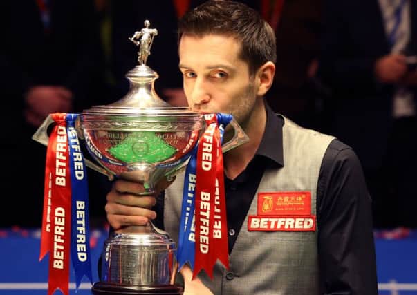 Mark Selby celebrates with the trophy after beating Ding Junhui in the final of the Betfred Snooker World Championships at the Crucible Theatre, Sheffield. (Picture: Mike Egerton/PA Wire)