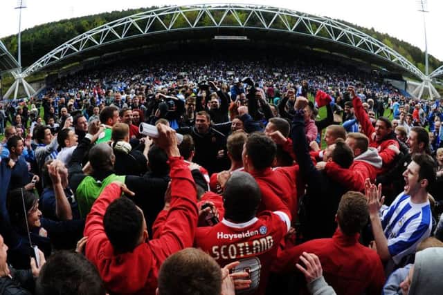 Huddersfield and Barnsley fans celebrate after survival in 2013