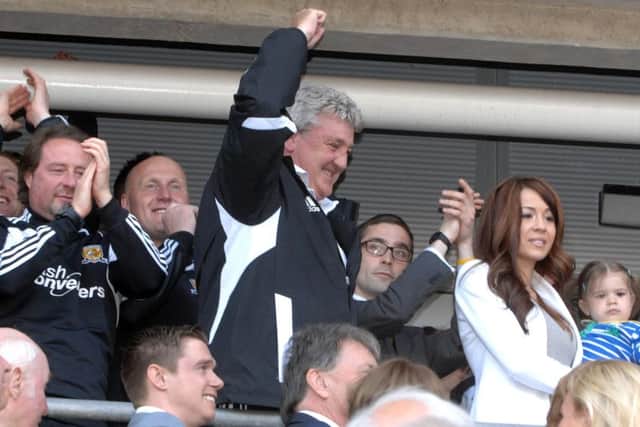 Hull City manager Steve Bruce celebrates promotion after the game against Cardiff City