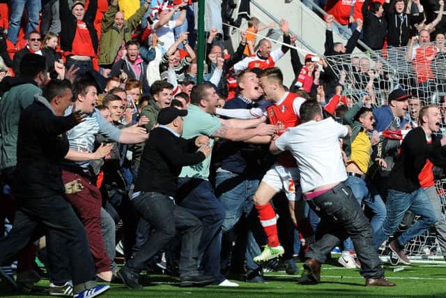 Rotherham United's Lee Frecklington celebrates scoring as the fans invade the pitch against Aldershot