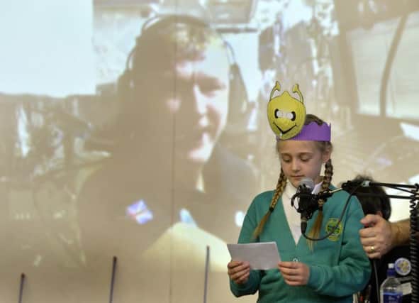 Grace Rhodes, Y5, asks Tim Peake " What would happen to a ballon in the ISS that isn't attached to a string?".Picture by Bruce Rollinson