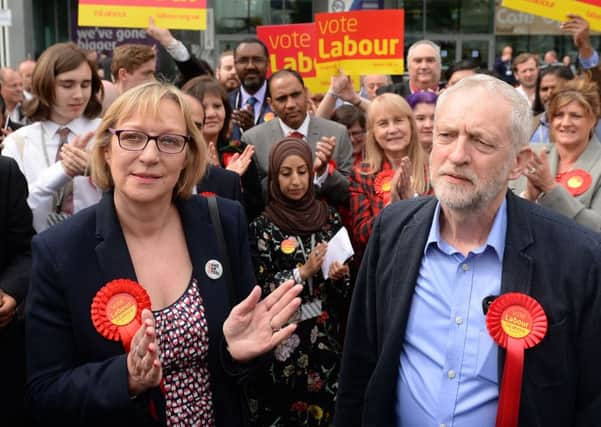 Labour party leader Jeremy Corbyn stands with Gill Furniss, whose husband Harry Harpham died from cancer, and who won the by-election to replace him in the Sheffield Brightside and Hillsborough parliamentary constituency. Joe Giddens/PA Wire