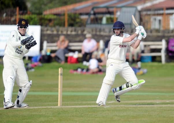 CUTTING LOOSE: Woodlands opener Sam Frankland hits a boundary in their Bradford League defeat to Pudsey St Lawrence. Picture: Steve Riding