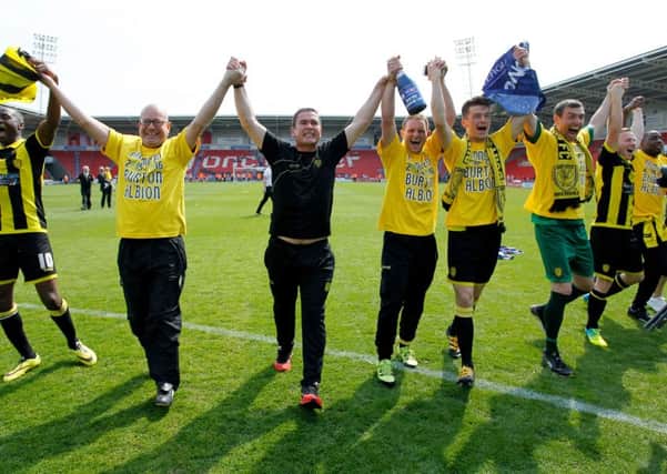 Burton Albion's manager Nigel Clough and players celebrate promotion at the Keepmoat Stadium.