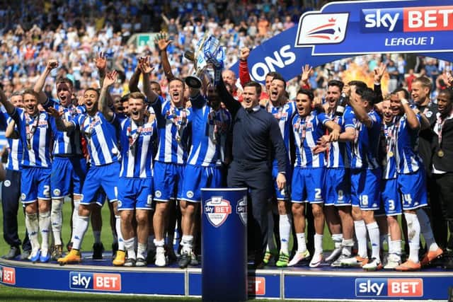 Wigan Athletic celebrate with the Sky Bet League One trophy