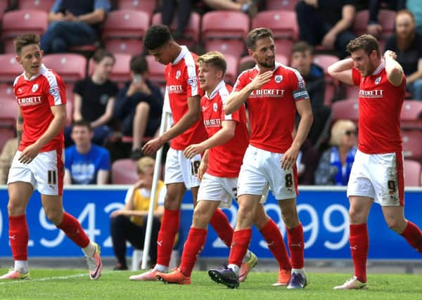 Barnsley's Conor Hourihane (second right) celebrates scoring his side's third goal of the game . Picture: Nigel French/PA.