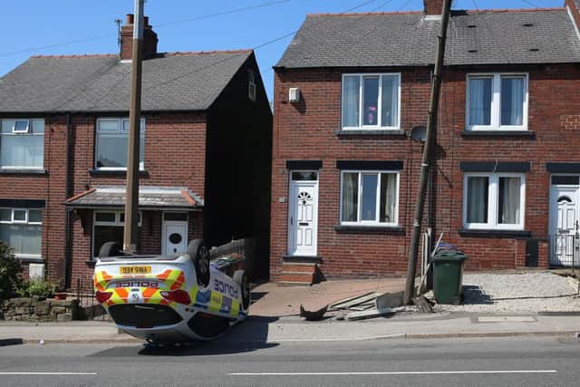 The police car on its roof on Carlton Road, Barnsley. Picture: Ross Parry Agency