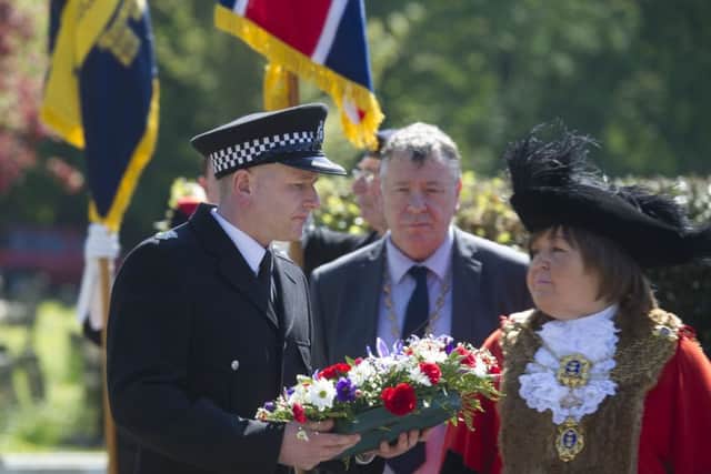 A representative of Humberside Police preparing to laying a wreath. Pictured with the Lord Mayor of Hull, Councillor Anita Harrison.
