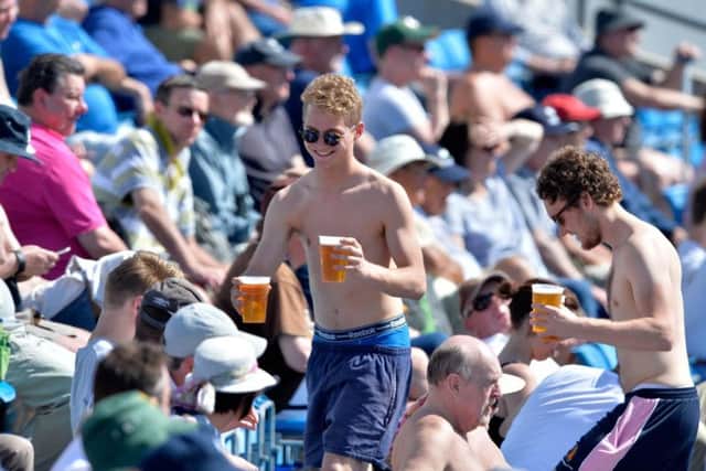 Crowds enjoy the spring sunshine as they watch Yorkshire play Surrey at the Carnegie Stadium in Headingley, Leeds, on Monday. Picture: Bruce Rollinson.