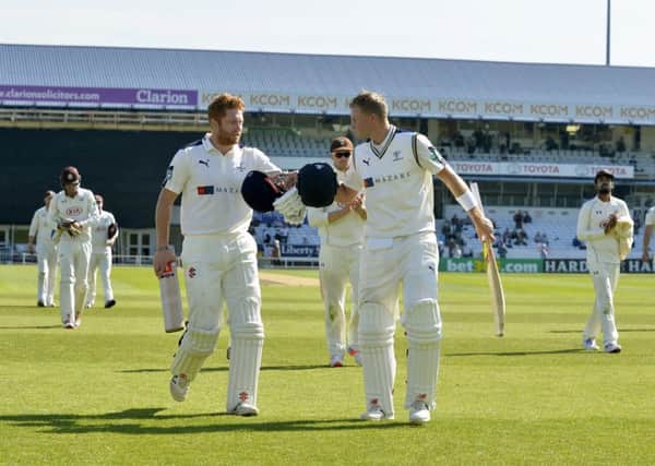 Jonny Bairstow, left, and Joe Root congratulate one another as they came off for tea during their record-breaking stand for Yorkshire (Picture: Bruce Rollinson).