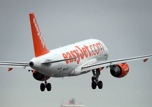 easyJet swung to a half-year loss after recent terror attacks saw some passengers stay away and rivals stepped up the pace of competition.