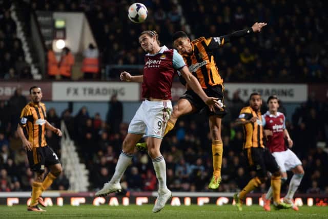 West Ham's Andy Carroll and Hull's Curtis Davies battle for a header during their Premier League match at Upton Park. Hull lost 2-1 . Picture: Anthony Devlin/PA.