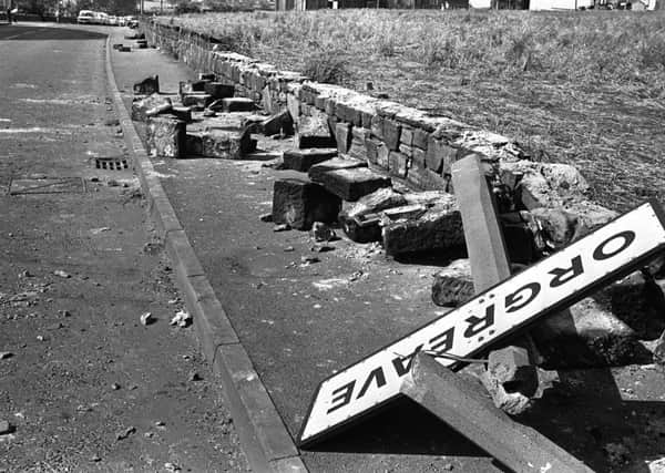 File photo dated 18/6/1984 of a twisted sign, felled concrete posts and a broken wall tell the story of violence outside a coking plant in Orgreave, South Yorkshire.