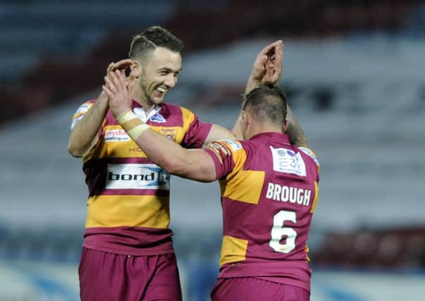 Danny Brough celebrates with Ryan Brierley after Huddersfield Giants knocked out holders Leeds Rhinos.