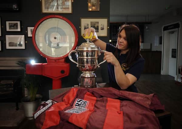 Jess Leighton polishes the Yorkshire Cup in preparation for the festival. PIC: Simon Hulme