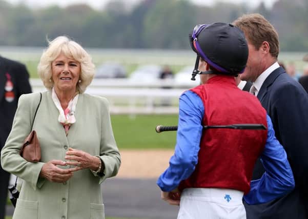 The Duchess of Cornwall speaks with jockey Fran Berry in the parade ring during day one of the Dante Festival at York Racecourse.