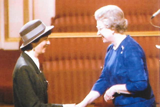 Receiving an MBE from the Queen in 1994. Harrod was the first woman to be able to stay in the Foreign Office after getting married.