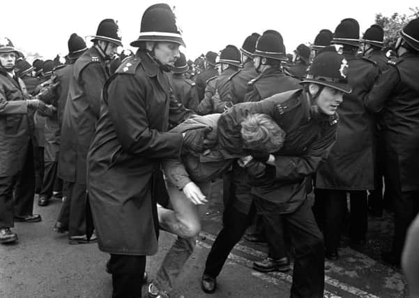 Police arrest a picket during the Miners' Strike.