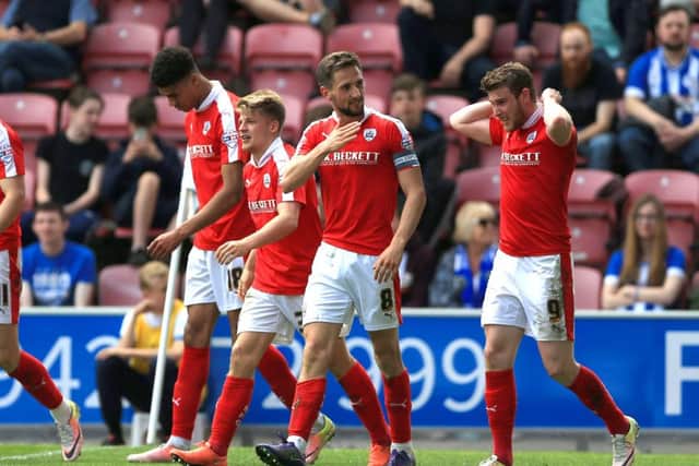 Barnsley's players celebrate one of their four goals against Wigan last Sunday. Picture: PA.